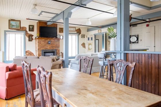 Wooden dining table by living area in Apartment 405 at Retro Suites Hotel