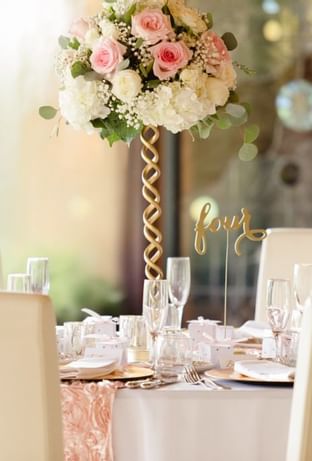 Dining table with flowers in the event room at Copamarina