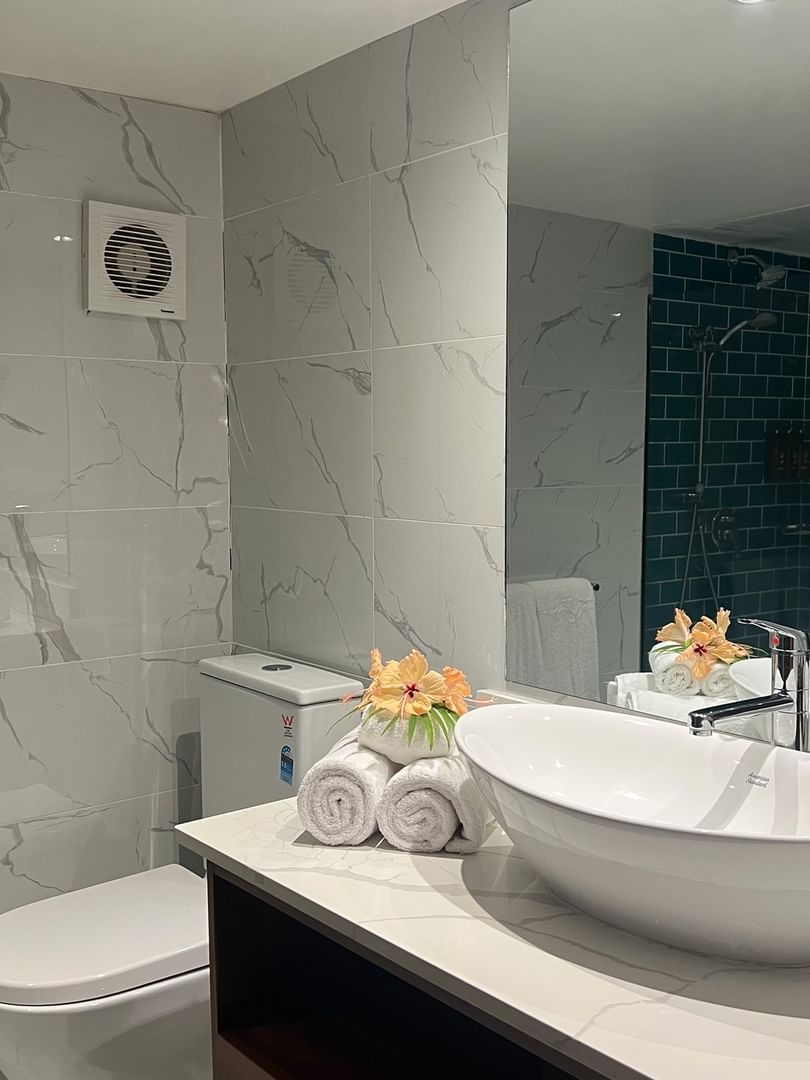 Elegant bathroom with white fixtures and toiletries in Deluxe Double Room at Warwick Fiji Korolevu.