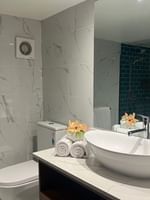 Elegant bathroom with white fixtures and toiletries in Deluxe Double Room at Warwick Fiji Korolevu.