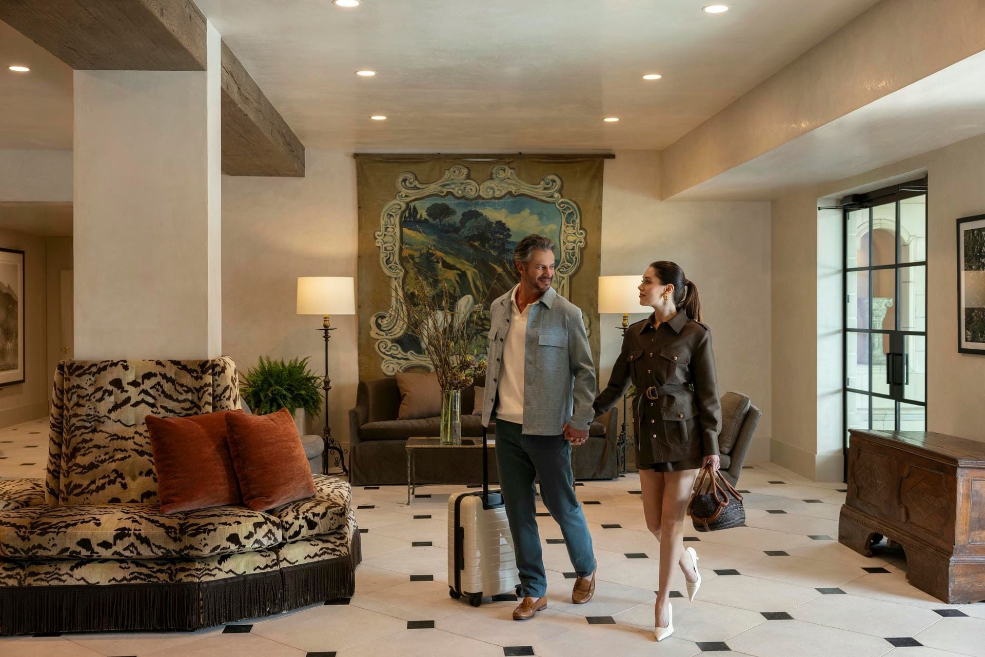 Couple walking hand-in-hand through the stylish lobby at Granduca Houston, one of the top boutique hotels in Houston, TX