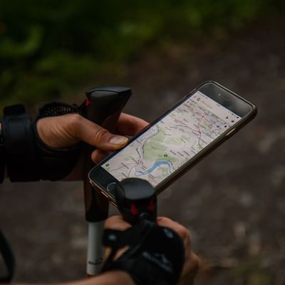 Reading a map on a phone near Falkensteiner Hotels