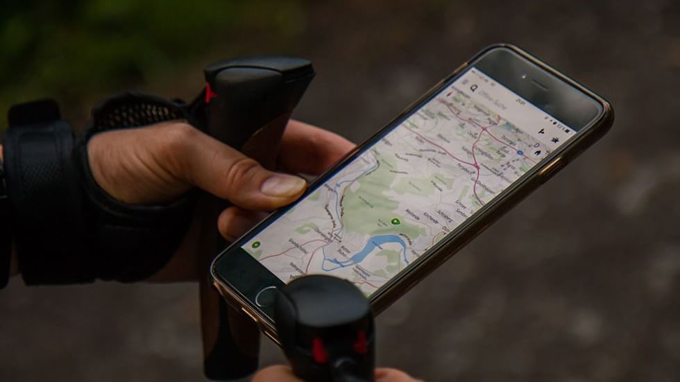 Reading a map on a phone near Falkensteiner Hotels