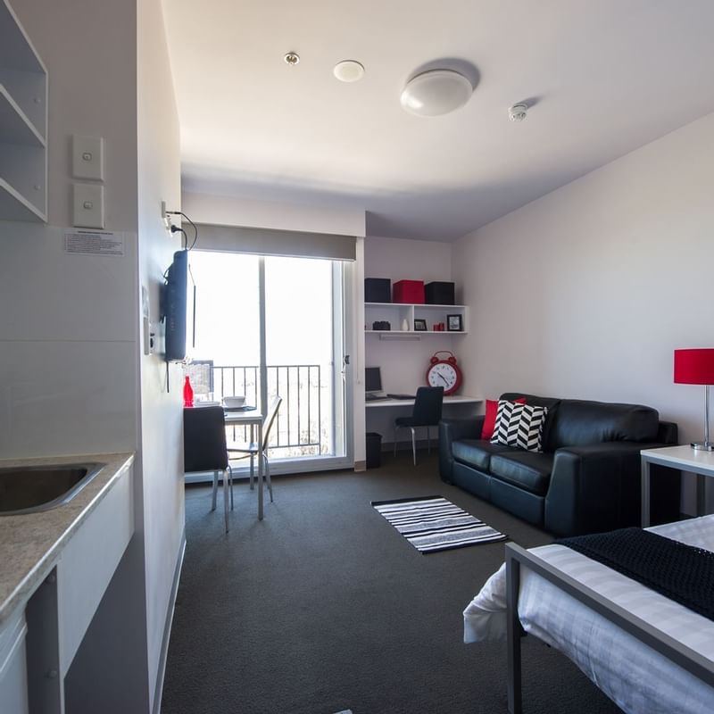 Typical studio single apartment featuring single bed, TV, study desk & chair, bedside table, dining table & chairs, 2 seat lounge, kitchenette and bathroom (not featured) - purchase hotel quality linen via our online shop, Your Shop