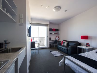 Typical studio single apartment featuring single bed, TV, study desk & chair, bedside table, dining table & chairs, 2 seat lounge, kitchenette and bathroom (not featured) - purchase hotel quality linen via our online shop, Your Shop