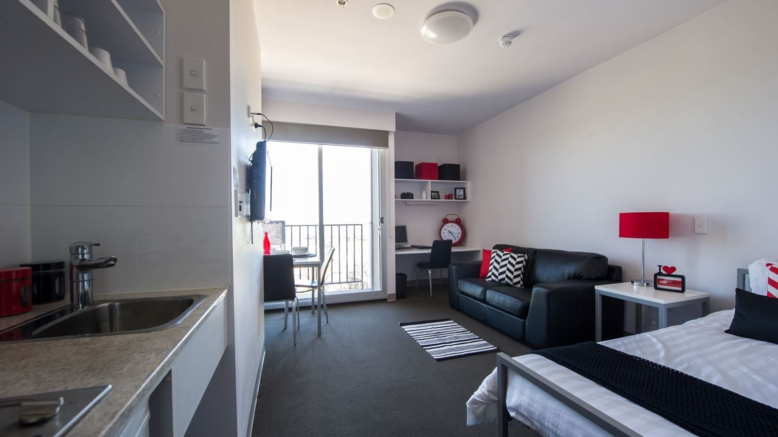 Typical studio single apartment featuring single bed, TV, study desk & chair, bedside table, dining table & chairs, 2 seat lounge, kitchenette and bathroom (not featured) - purchase hotel quality linen via our online shop, Your Shop