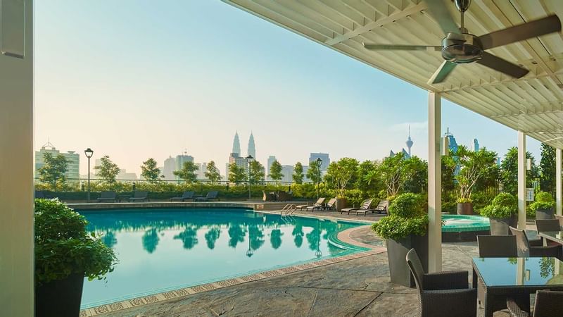 Exterior view of hotel pool with sunbeds at Sunway Putra Hotel