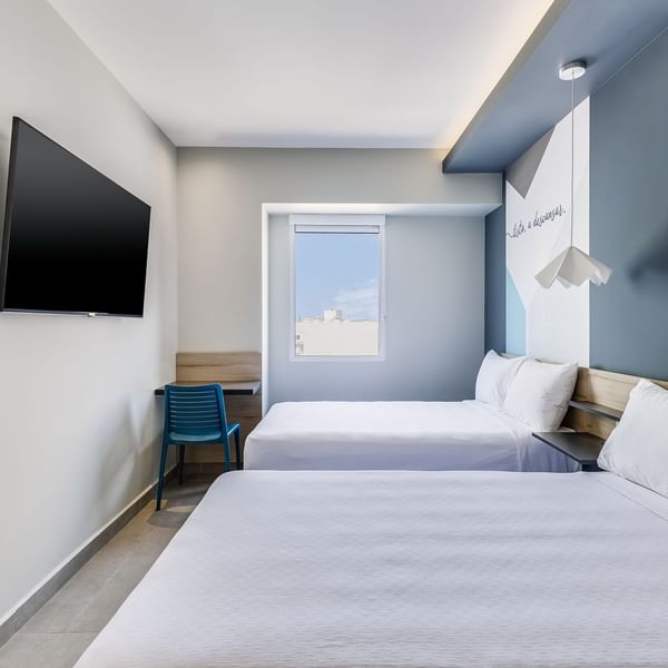King bed with a TV in Standard Double at One Hotels