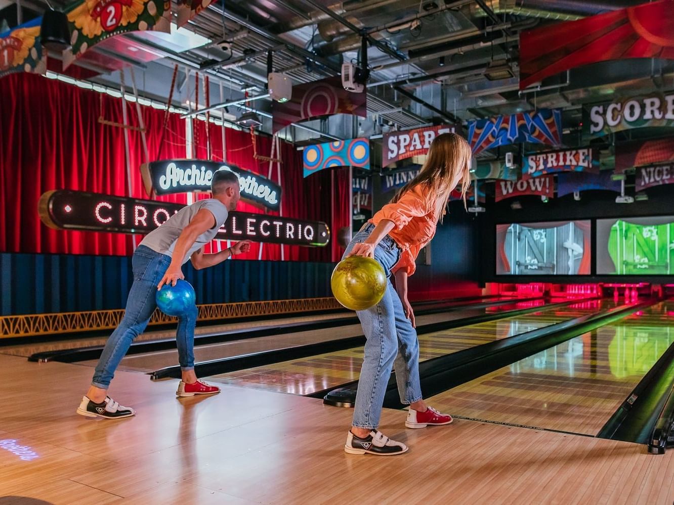 Two friends enjoying bowling in Archie Brothers Cirque Electriq near Nesuto Docklands