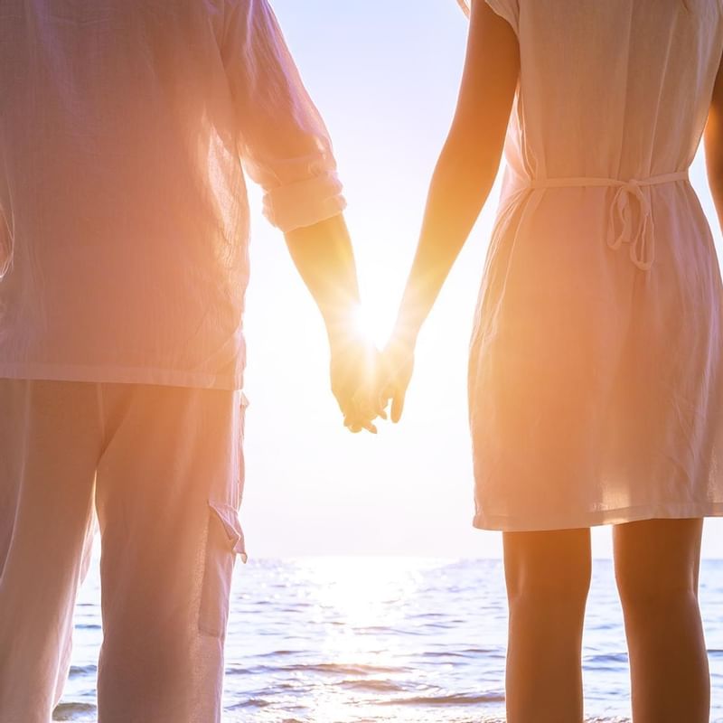 A couple on honeymoon beach near the Warwick Le Lagon