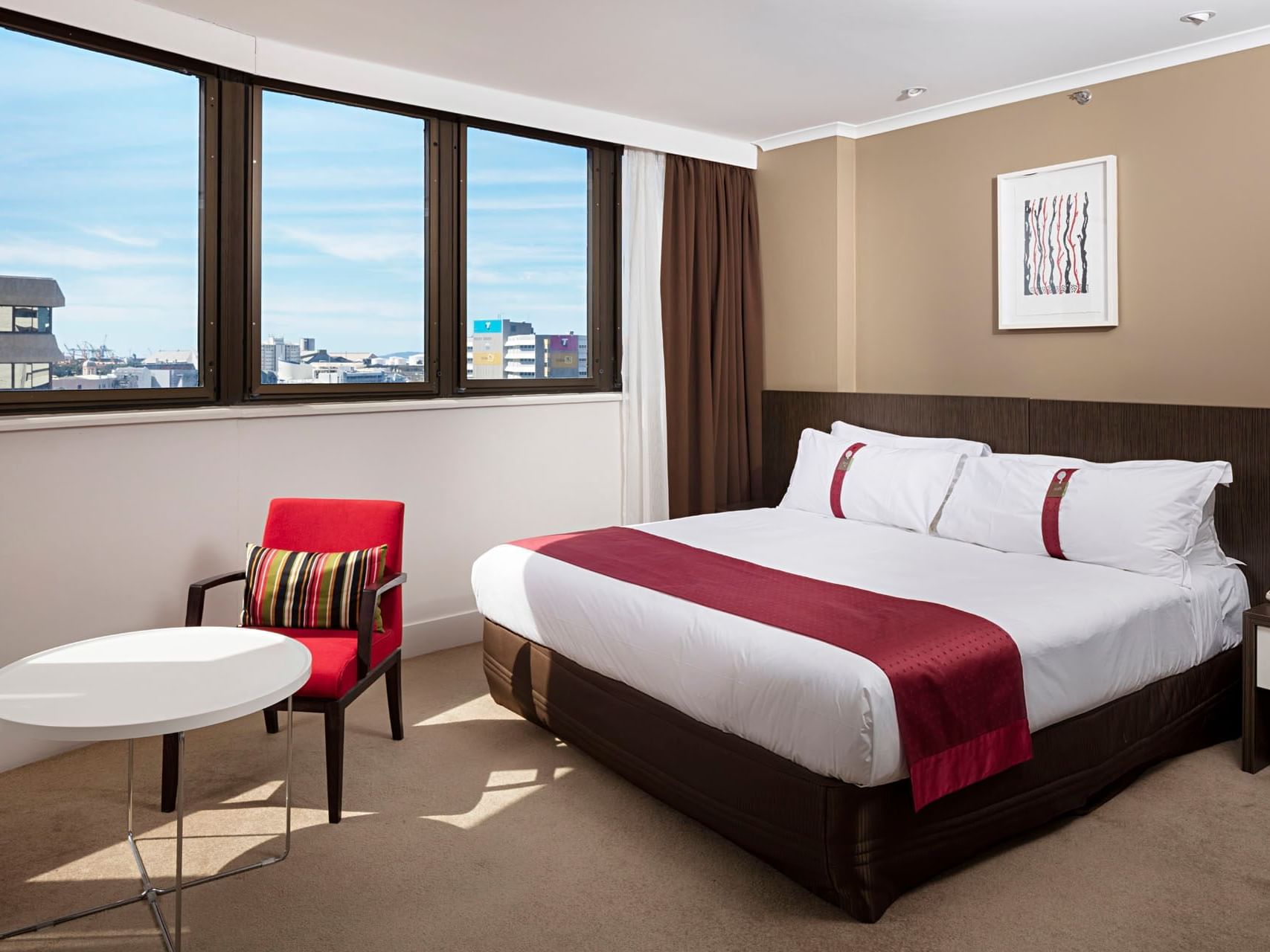 Bed & lounge in Standard King with a city view at Grand Chancellor Townsville