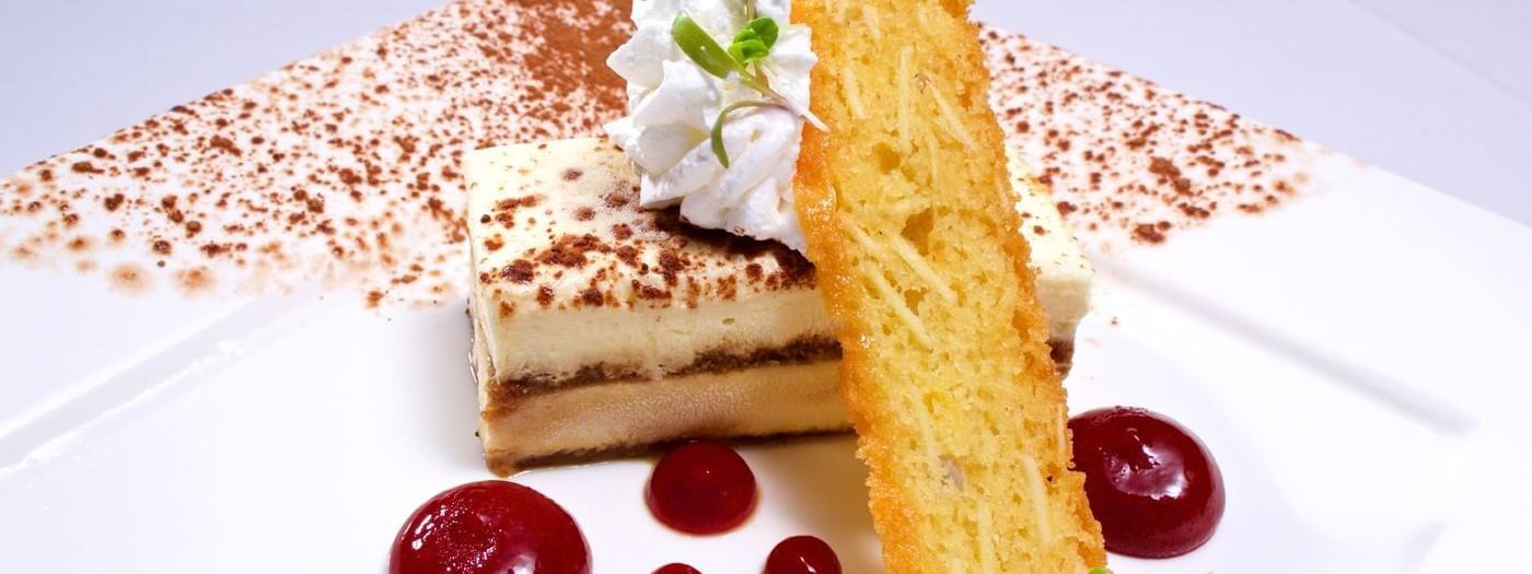 Layered cake with fruit coulis under a chocolate-dusted surface in Abbiocco  at Warwick Paradise Island Bahamas 