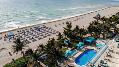 Outdoor pool, sun beds on the beach at Marenas Resort Miami