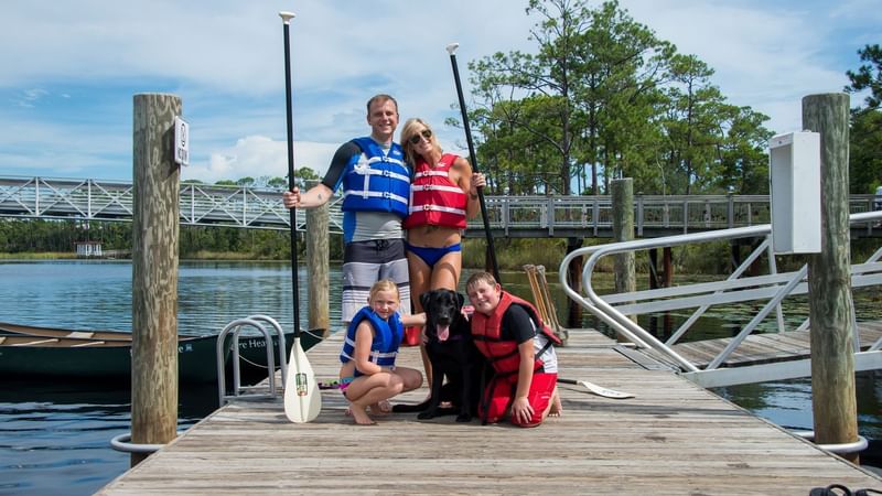 A family with the dog giving pose on deck at WaterColor Inn
