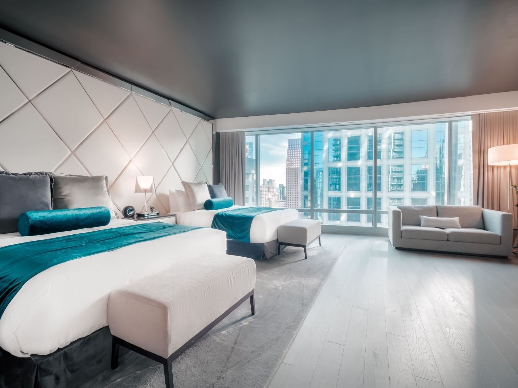 Executive Two Queen room with large windows and city view at Paradox Vancouver in Vancouver.