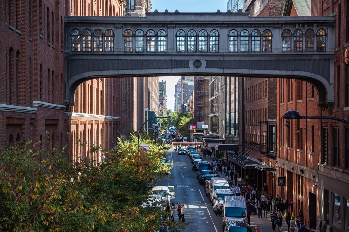 Elevated walkway with an arched design spans over a busy city street at Warwick New York