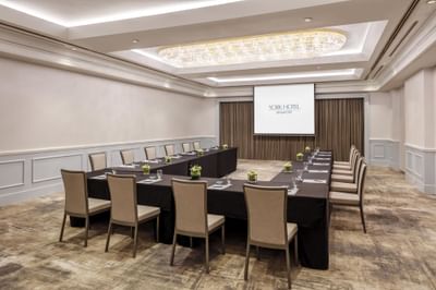 Conference room with U-shaped table and projector screen at York Hotel Singapore