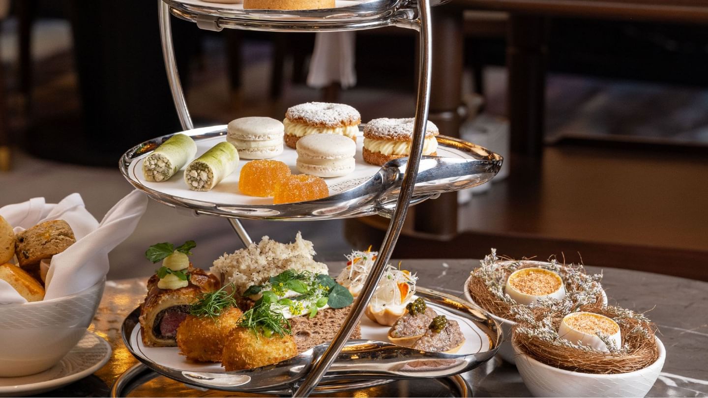 A delectable three-tiered high tea spread with pastries and savory bites, promoting a high tea offer at Sunway Hotel Pyramid