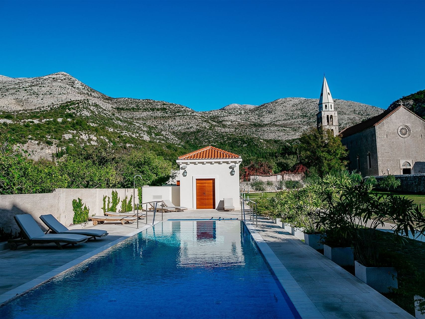 The Hotel pool with sun beds at Pervanovo Vila Riva Apartments