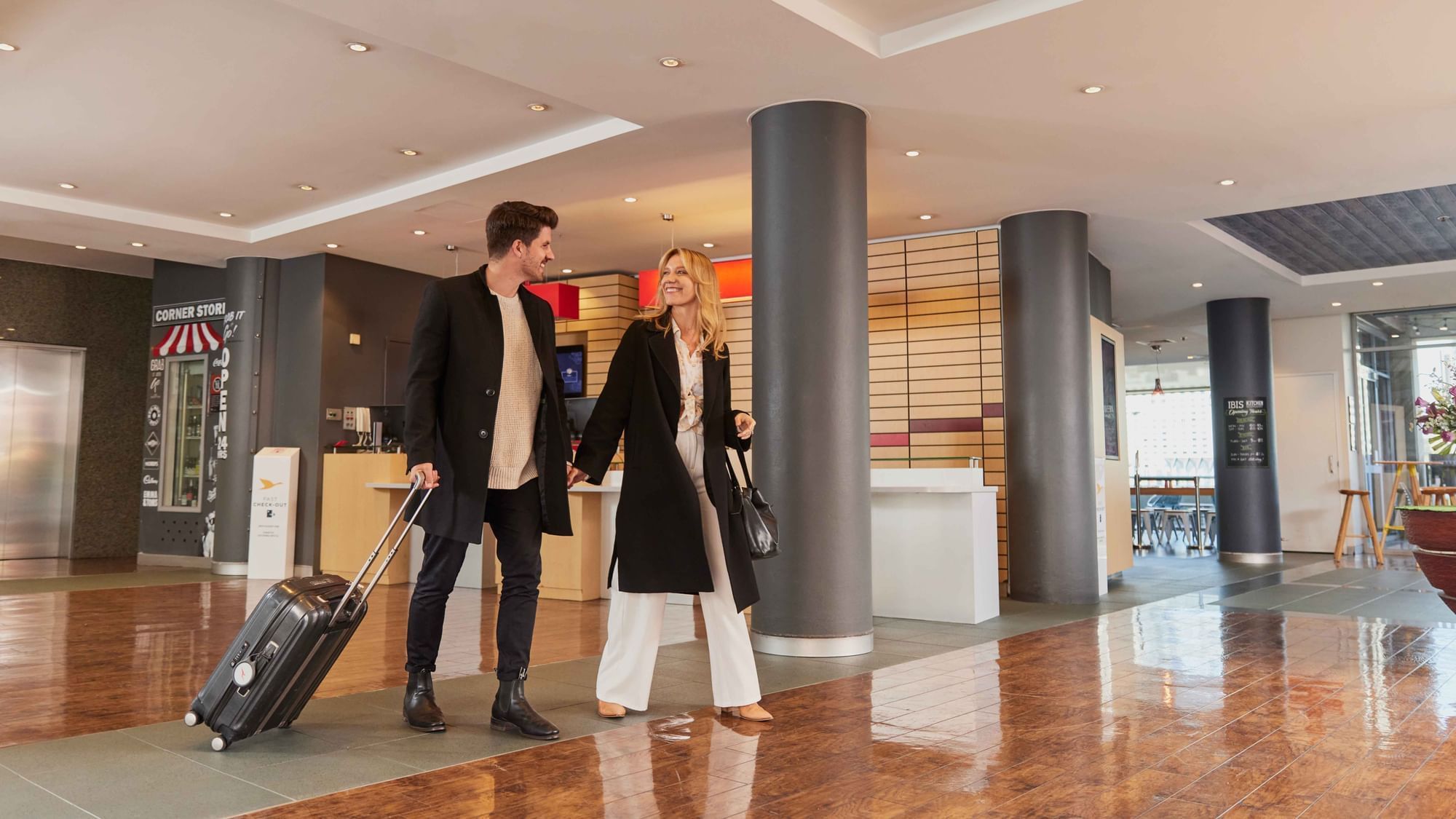 Couple checking into ibis Darling Harbour
