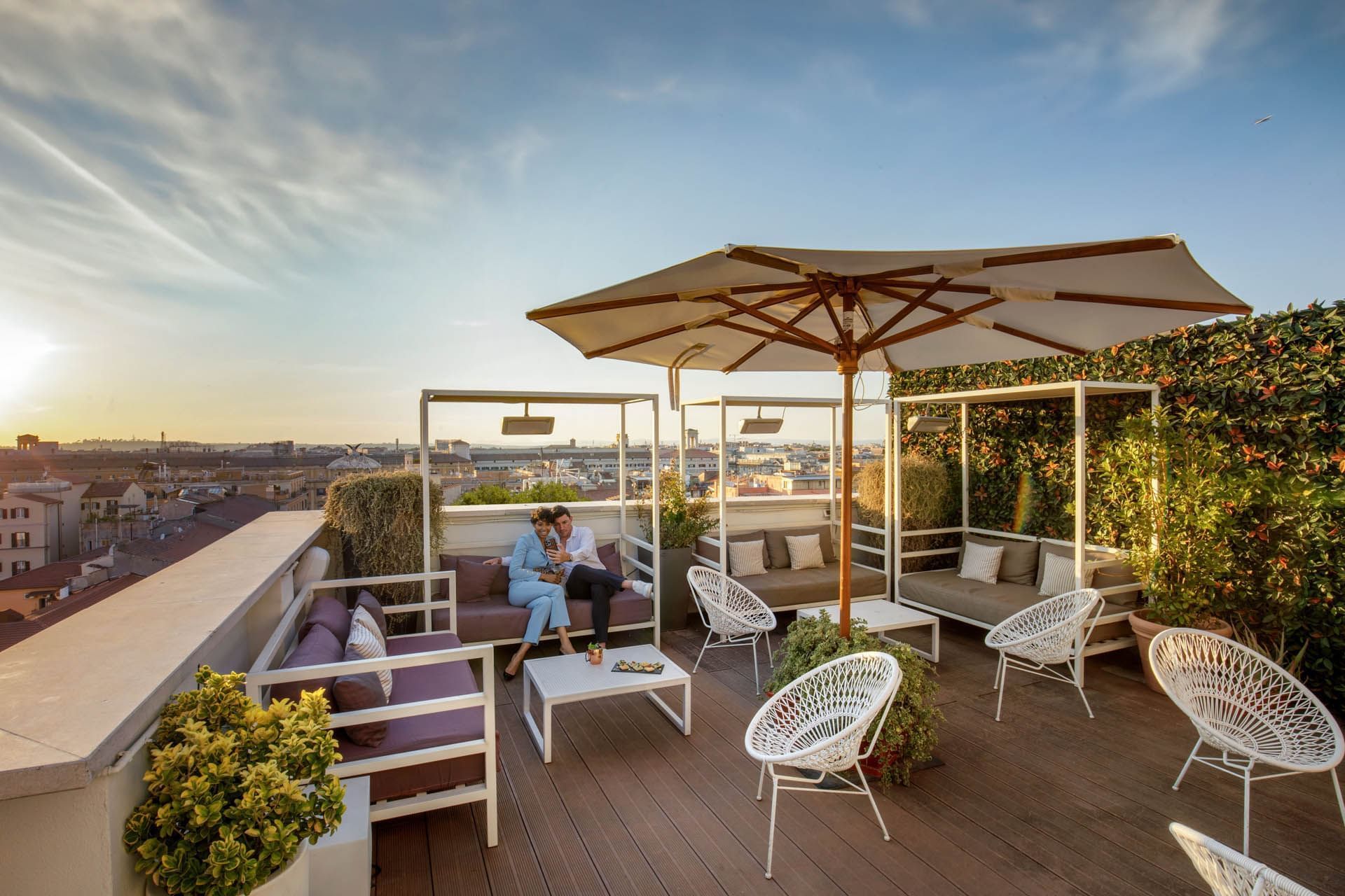 Couple at the Breakfast with a View of Rome, rooftop with umbrellas, overlooking the city at The Independent