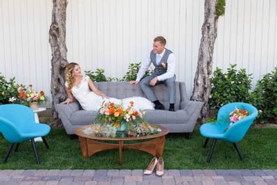 A wedded couple posing on a sofa at Anaheim Hotel