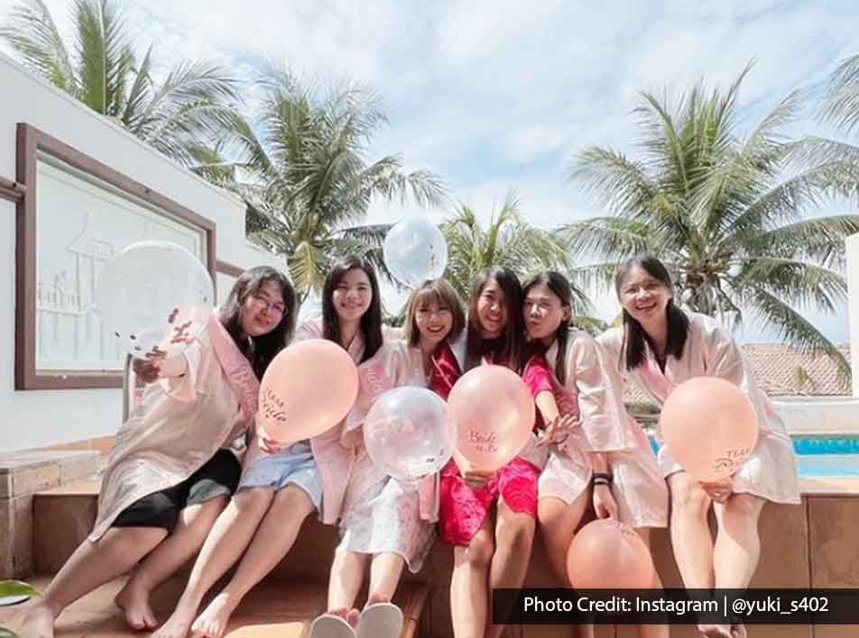 a group of joyful young women celebrating a bachelorette party with balloons - Grand Lexis PD