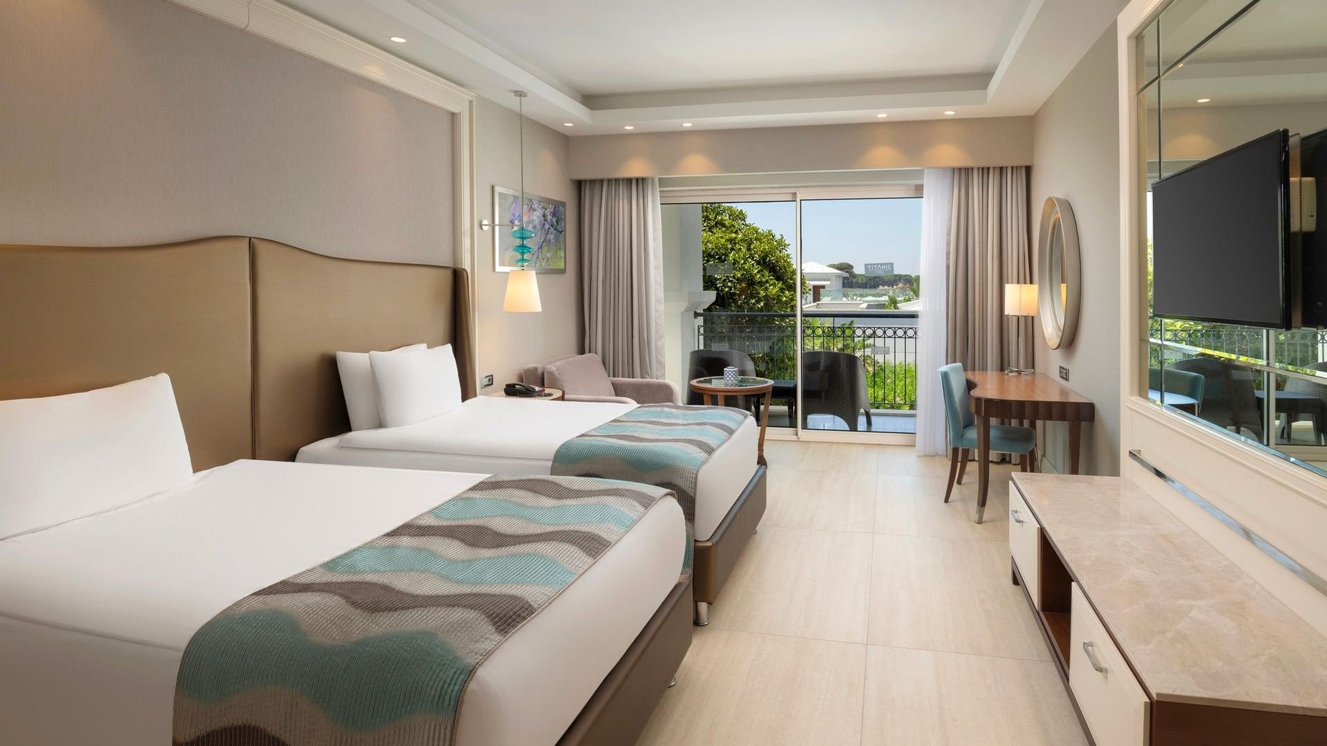 Spacious Family Pool Suite Balcony with twin beds, modern furnishings, and balcony access at Titanic Deluxe Golf Belek.