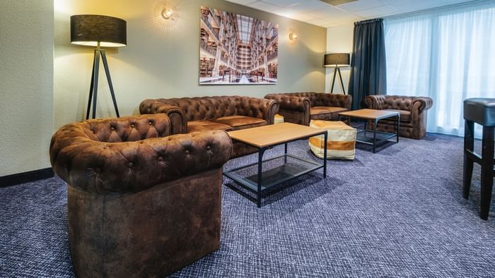 Living area with sofas in a suite at The Originals Hotels