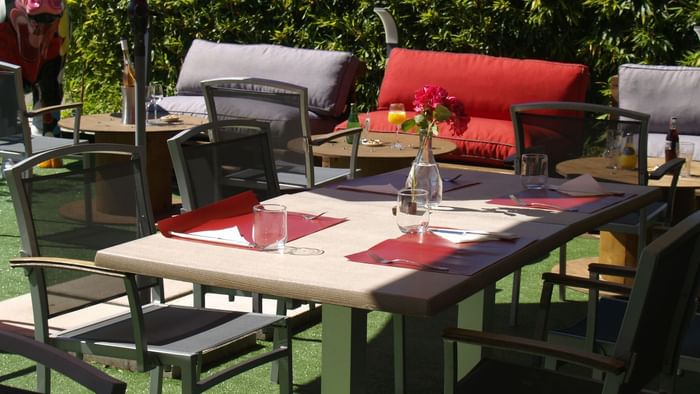 Outdoor dining table set-up in a restaurant at Originals Hotels