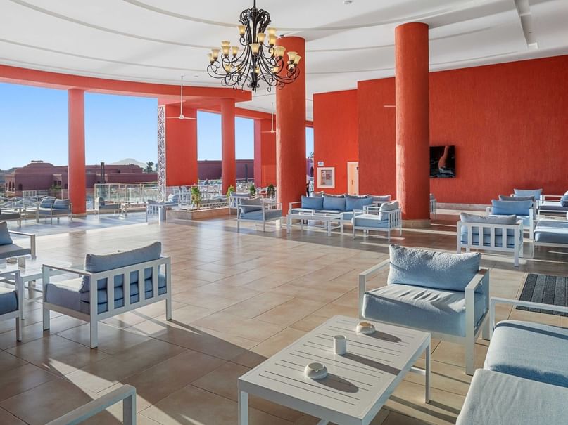 Elegant Terrace Bar with white furniture and red columns at Pickalbatros Laguna Vista Hotel in South Sinai Governorate.