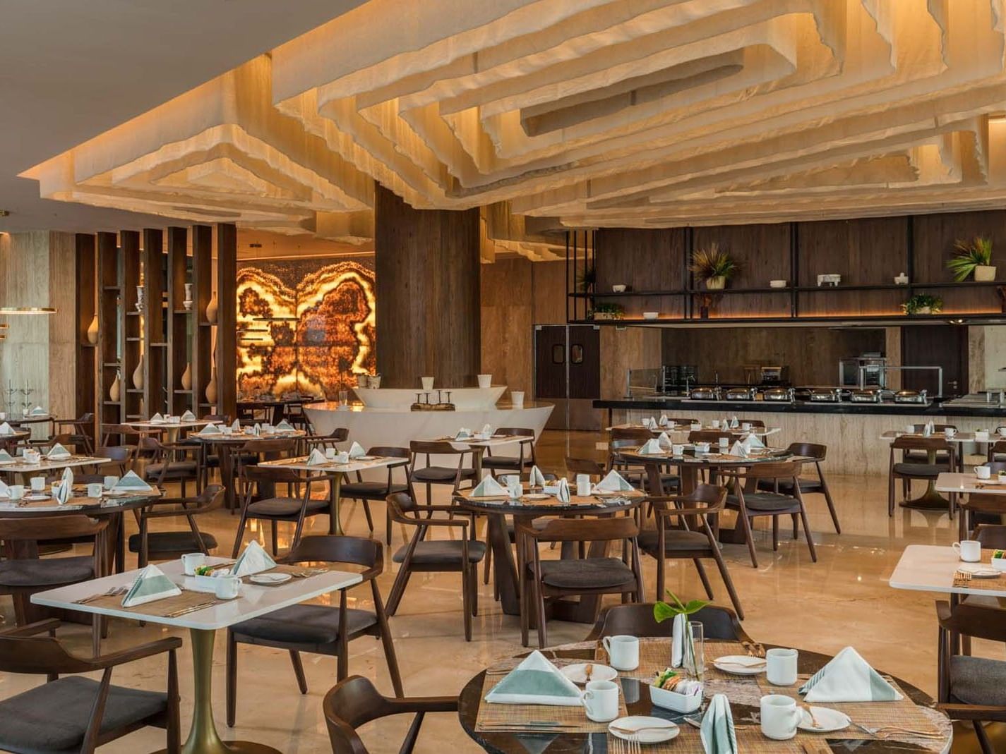 La Huerta dining room with unique layered ceiling decor and elegant wooden furniture at Camino Real Merida