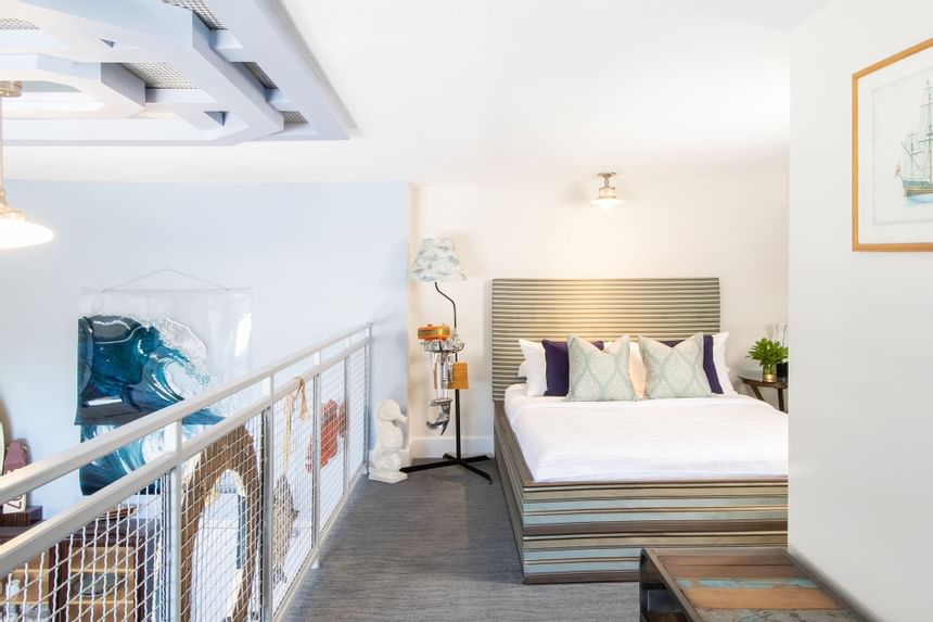 Bedroom, handrail & overview of the living area in Superior Loft Sail Inn at Retro Suites Hotel