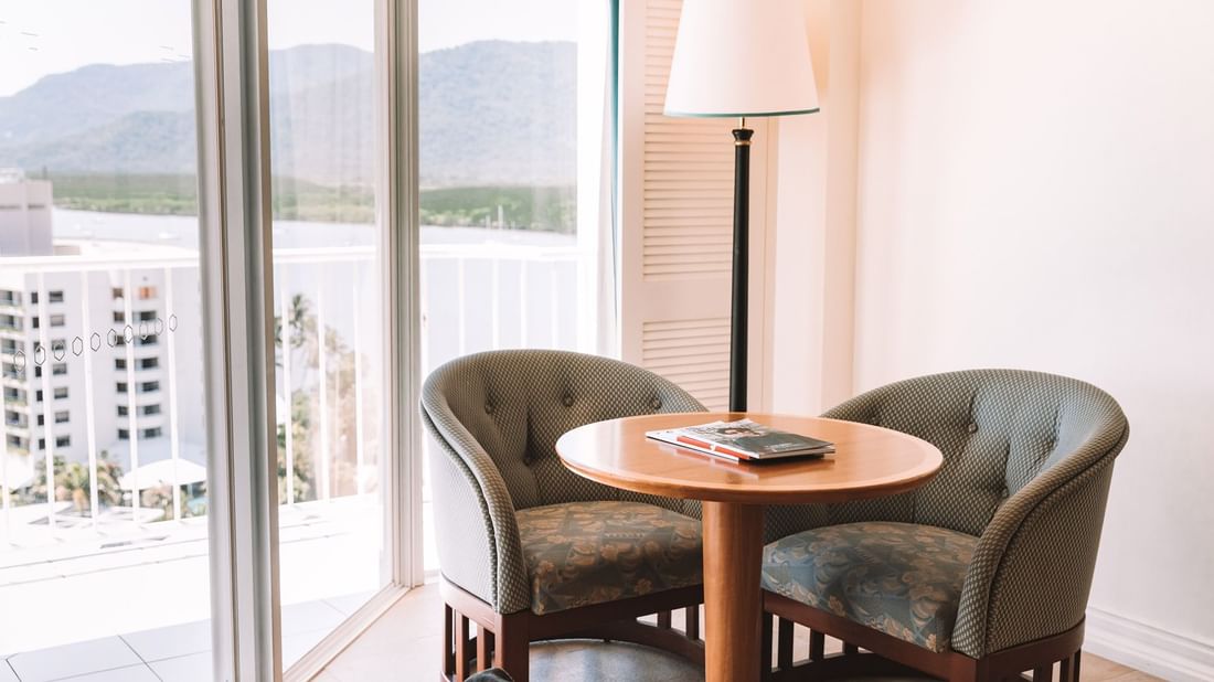 Two cozy chairs in Classic Harbour View Room at Pullman Cairns