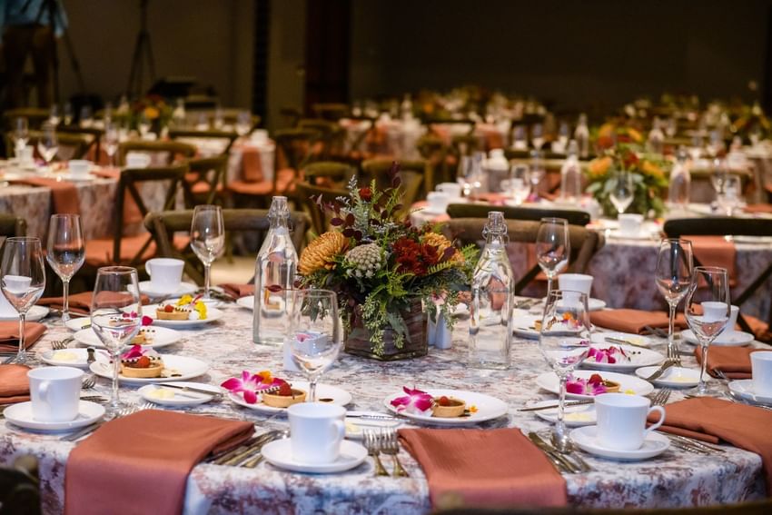 Banquet tables with floral centerpieces and plated desserts for a reception at Clemson University Conference Center & Inn