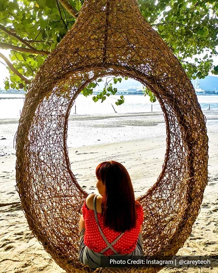 A woman was sitting in a giant bird nest at Pulau Jerejak - Lexis Suites Penang