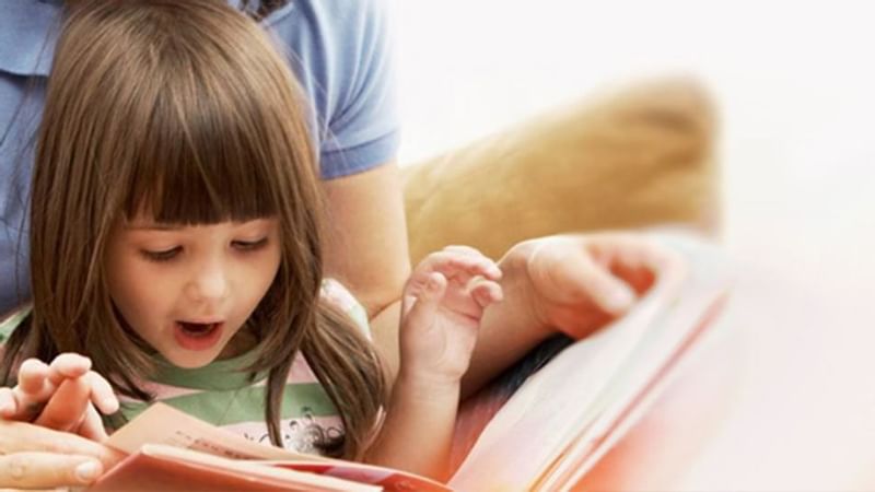 Close-up of a kid reading a book at Luxury Suites Amsterdam