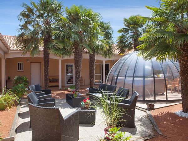 Back patio with lounges & glass dome at Theo Hotel Limoges Nord