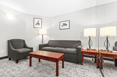 Living area with cozy sofa and framed local art at Rosedale on Robson Suite Hotel, one of the best hotels in Vancouver