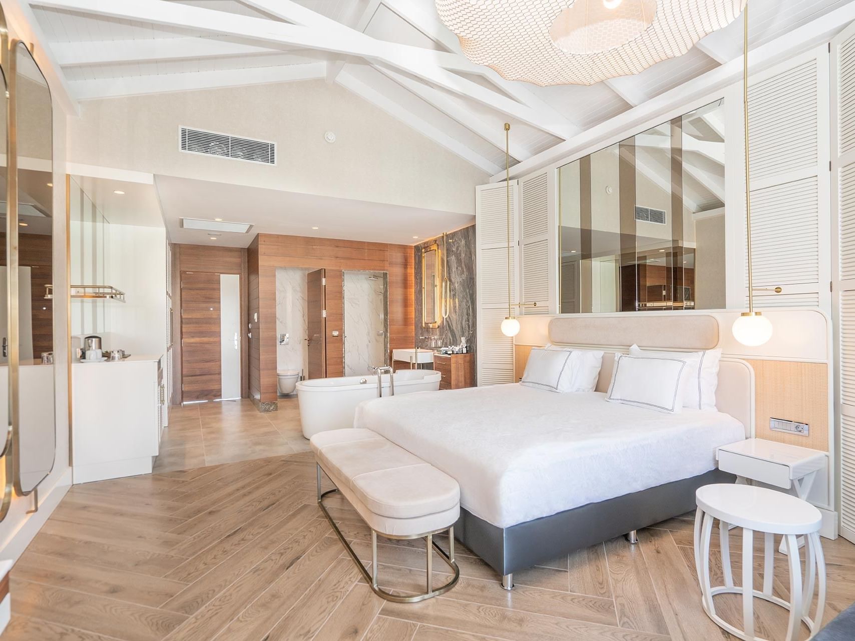 Comfy bed with side tables and washroom in Maldive House at Titanic Deluxe Golf Belek