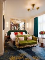 Deluxe King with bed and sofa near window and doorway to bathroom at The Capital Hotel, Apartments and Townhouse