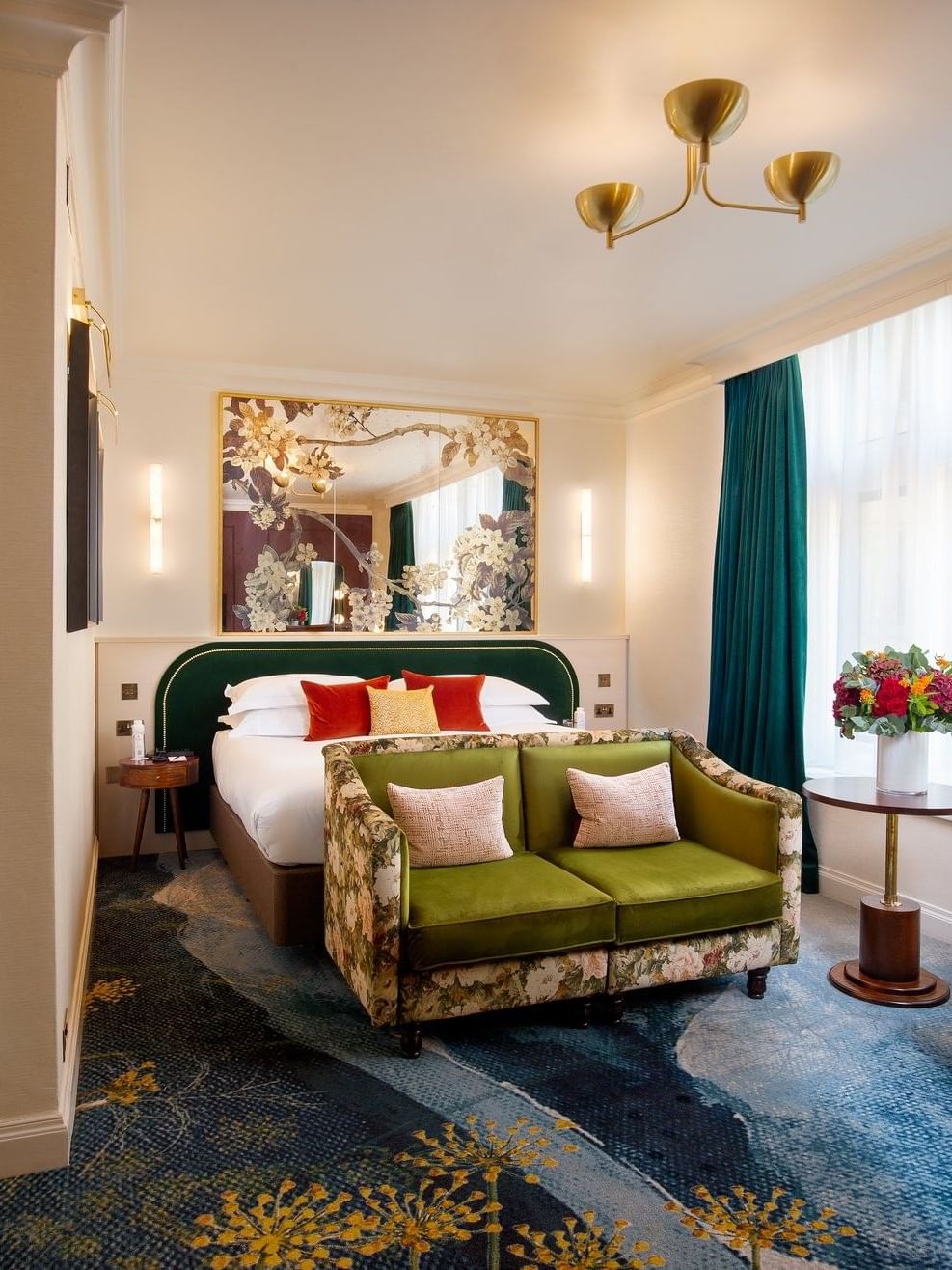 Deluxe King with bed and sofa near window and doorway to bathroom at The Capital Hotel, Apartments and Townhouse