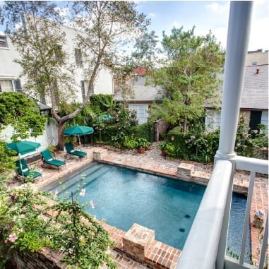 The exterior view of the outdoor pool area at Audubon Cottage