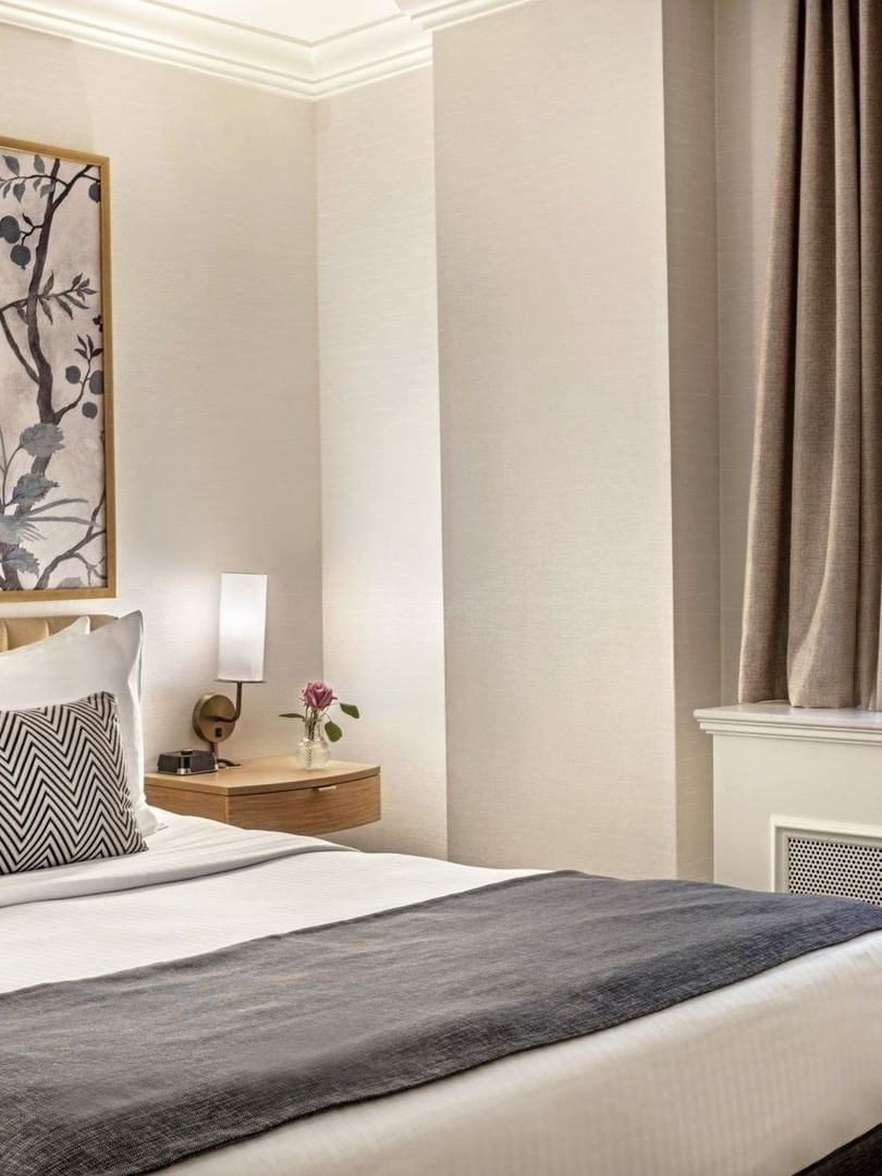 Bed with side tables near window in Petite Classic at Warwick Allerton Chicago