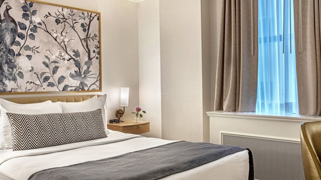 Bed with side tables near window in Petite Classic at Warwick Allerton Chicago