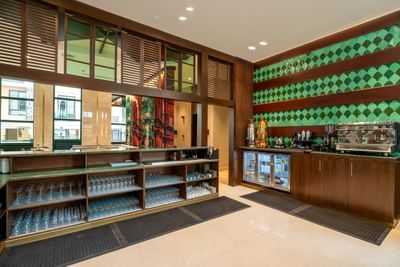 Beverage counter with shelves in Lobby Café at Naviti by Warwick Jeddah, offering fine dining at a Boutique Hotel in Jeddah