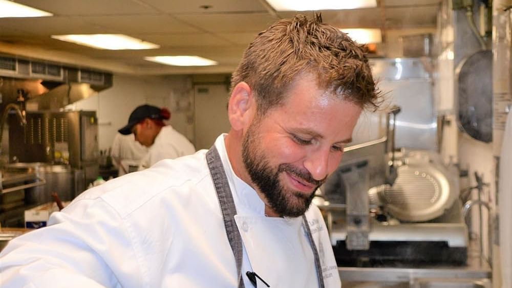 Chef Evan preparing meals in a kitchen at Chateaux Deer Valley