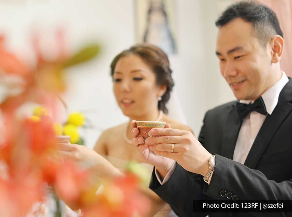 A couple was holding tea during a Chinese tea ceremony - Lexis Suites Penang