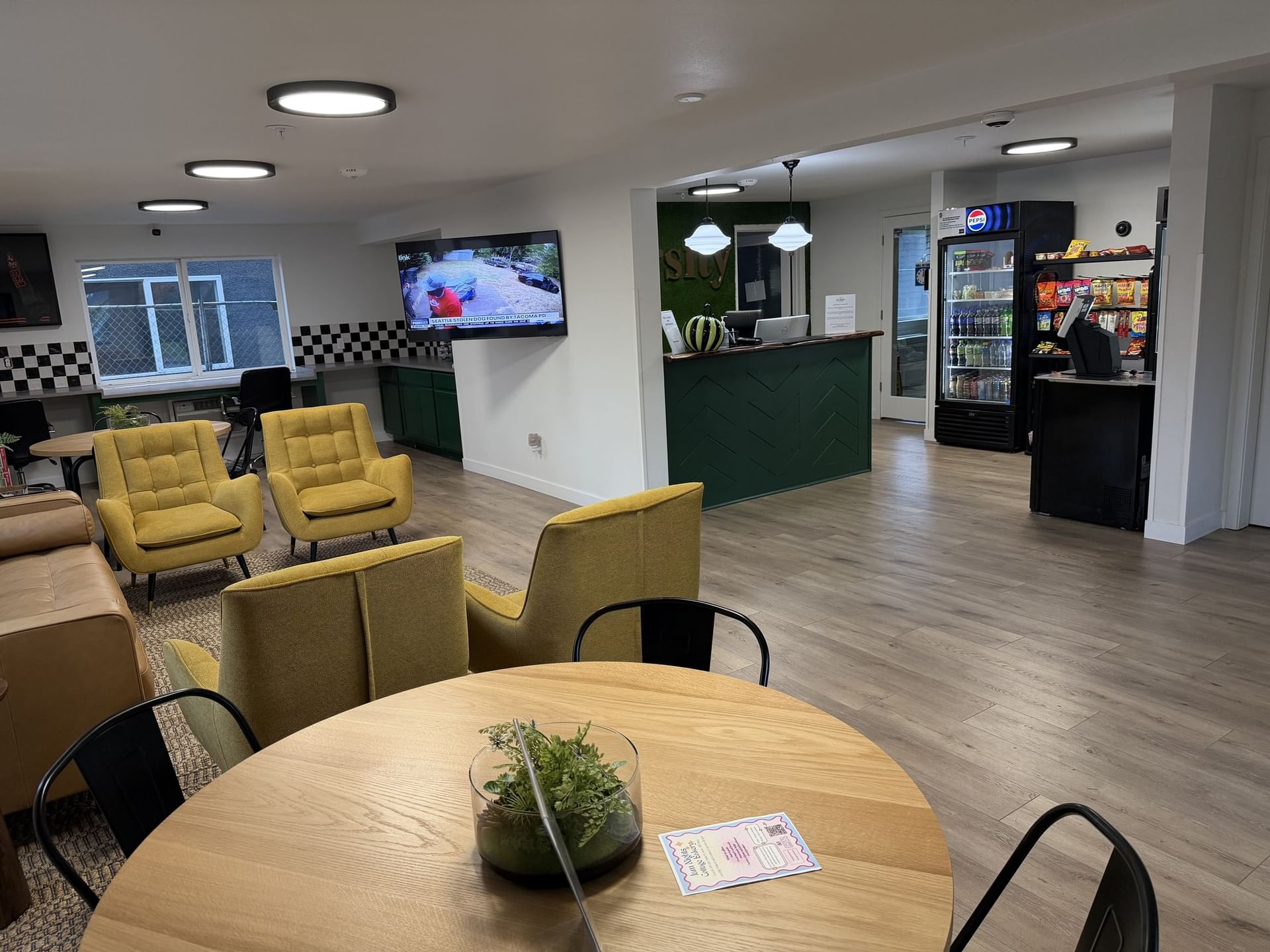 Lobby lounge with a reception desk and a snack area at The Varsity North, highlighting modern hotels in Centralia, WA
