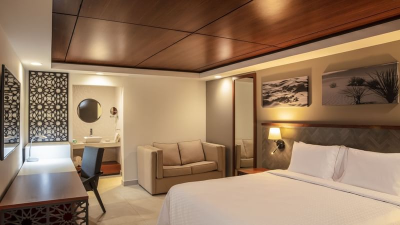 Beds, mirror, table & vanity at Gamma Ciudad Juarez